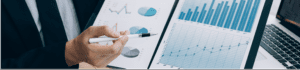 man holding a pencil towards a graph