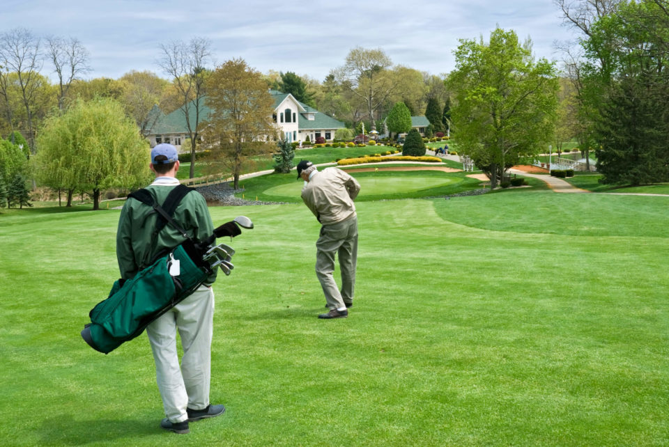 caddy and man playing golf